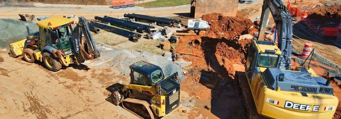 Earthmoving equipment at a construction site. How to review a construction contract.